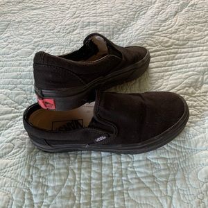 All black slip on vans